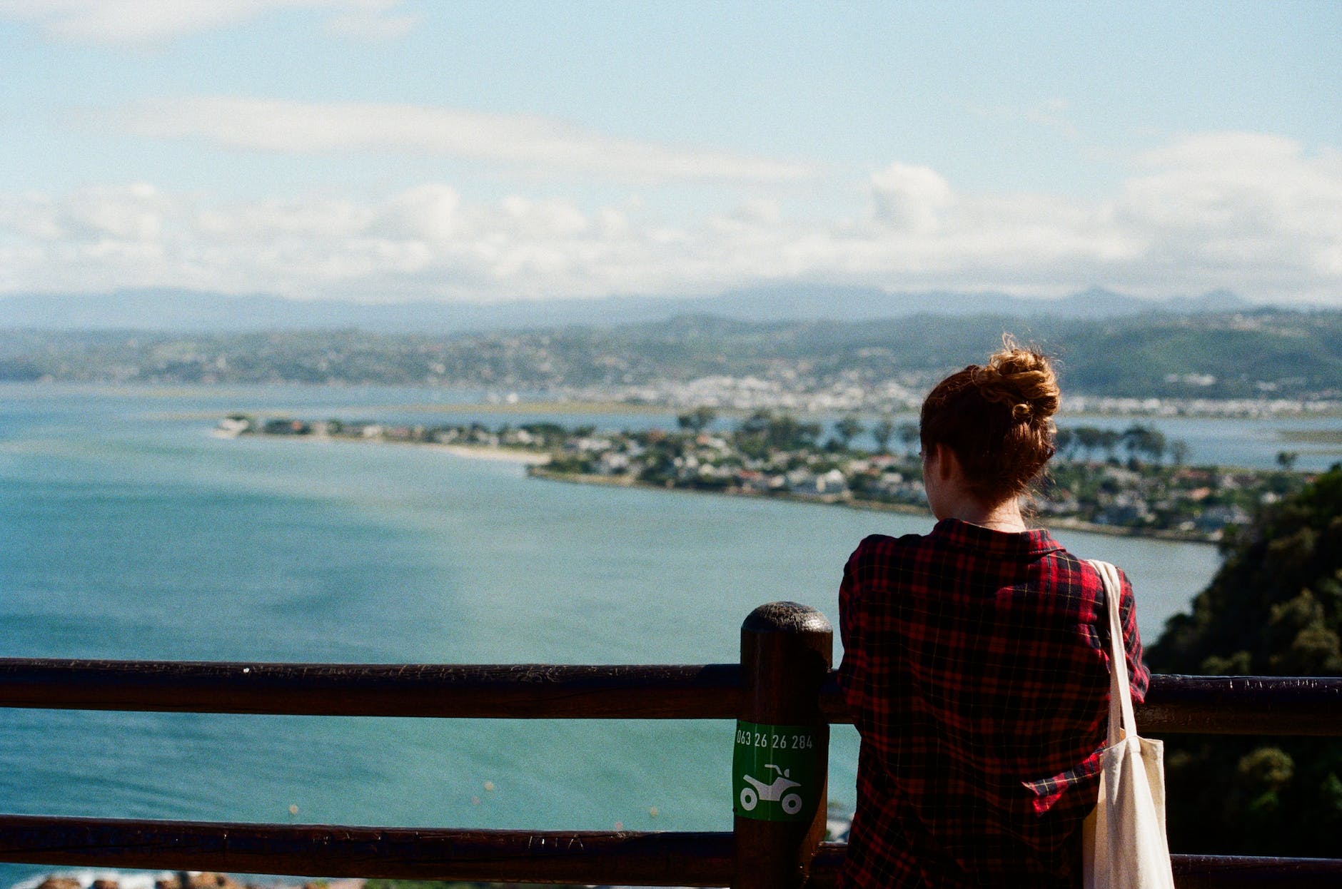 woman standing on an observation terrace and looking at the bay