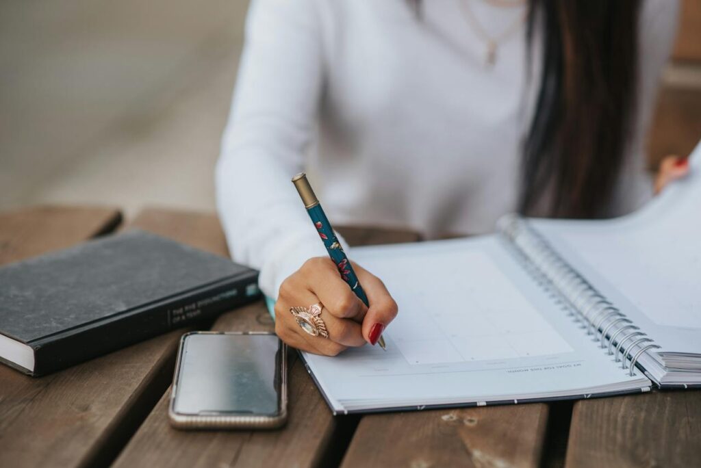 Photo by Anete Lusina: https://www.pexels.com/photo/crop-office-employee-taking-notes-in-notebook-at-table-5239793/