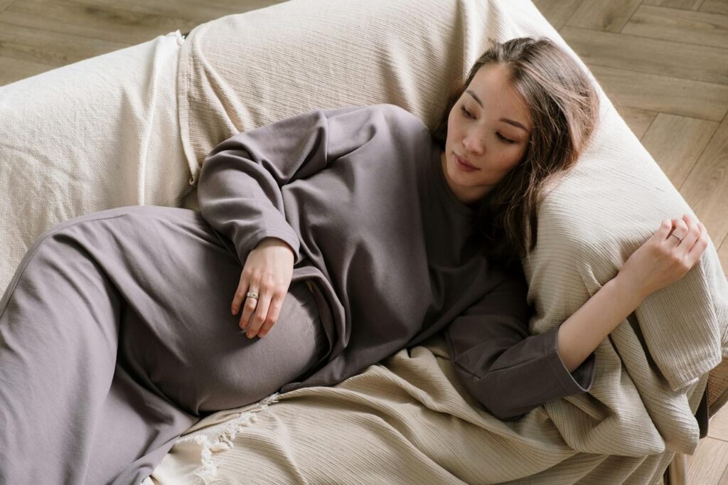 Photo by cottonbro studio: https://www.pexels.com/photo/a-pregnant-woman-lying-on-a-couch-5853832/