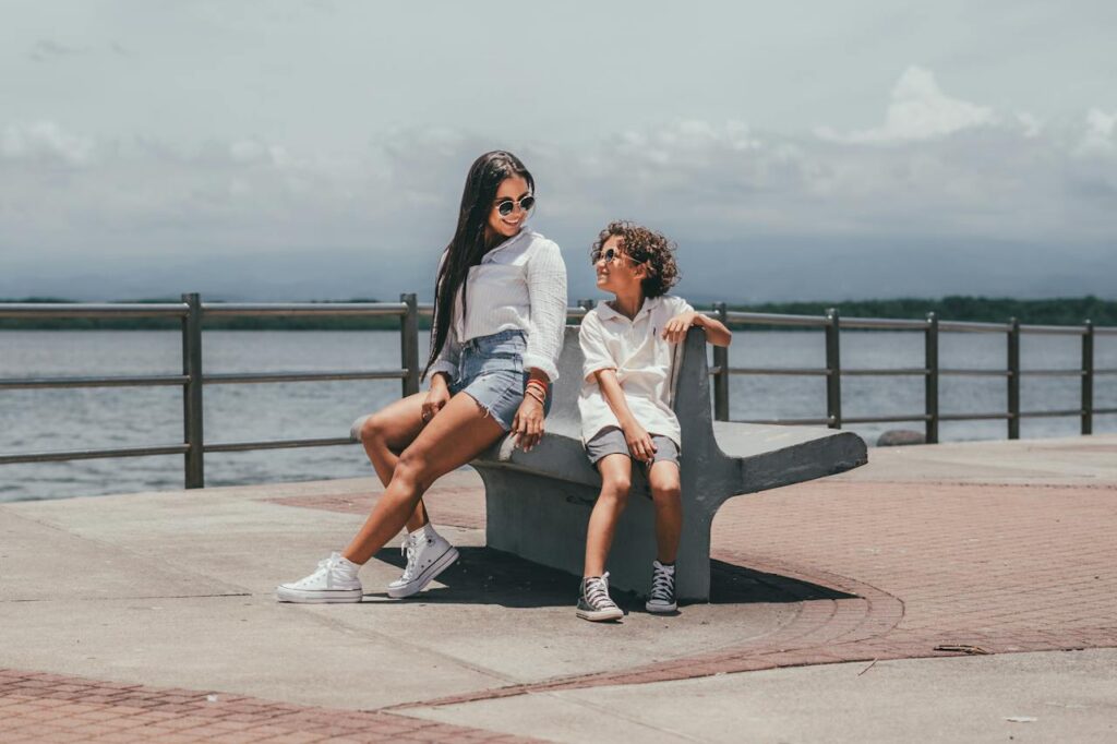 Photo by George Chambers: https://www.pexels.com/photo/woman-sitting-on-a-pier-with-her-son-and-smiling-19817275/